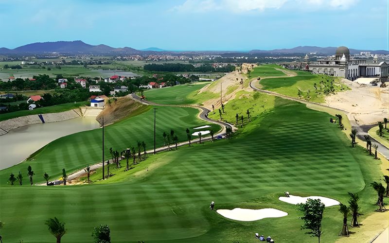 Aerial view of Stone Highland Golf Resort featuring striped fairways, white sand bunkers, and surrounding countryside landscape in northern Vietnam.