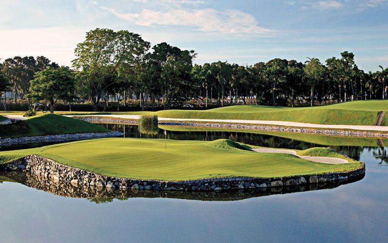 Island green at Laguna National Golf Resort Club in Singapore, surrounded by water and lush landscape, ideal for skilled golfers