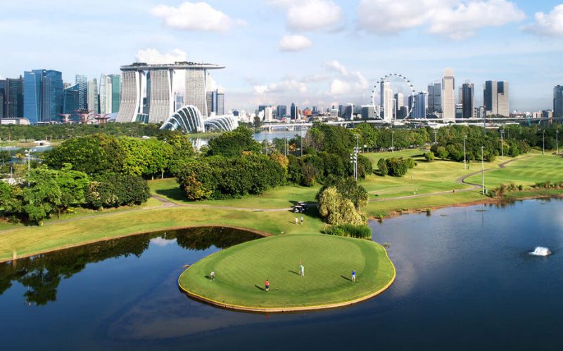 Marina Bay Golf Course in Singapore with city skyline, iconic landmarks, and island green surrounded by water