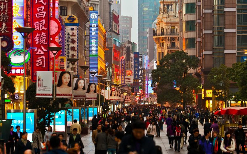 Strolling past luxury boutiques and local stores on Nanjing Road