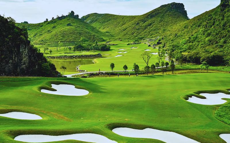 Legend Valley Country Club in Vietnam surrounded by lush green mountains, rolling fairways, and water features.