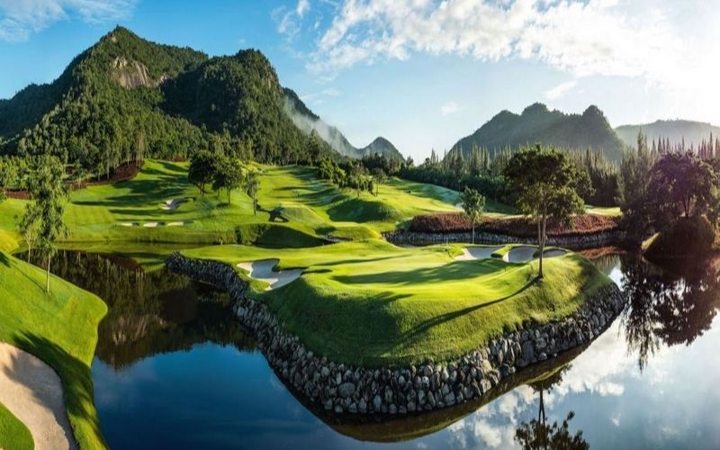 Beautiful view of Black Mountain Golf Club in Hua Hin, Thailand, featuring green fairways, mountain backdrop, and reflective water hazards.