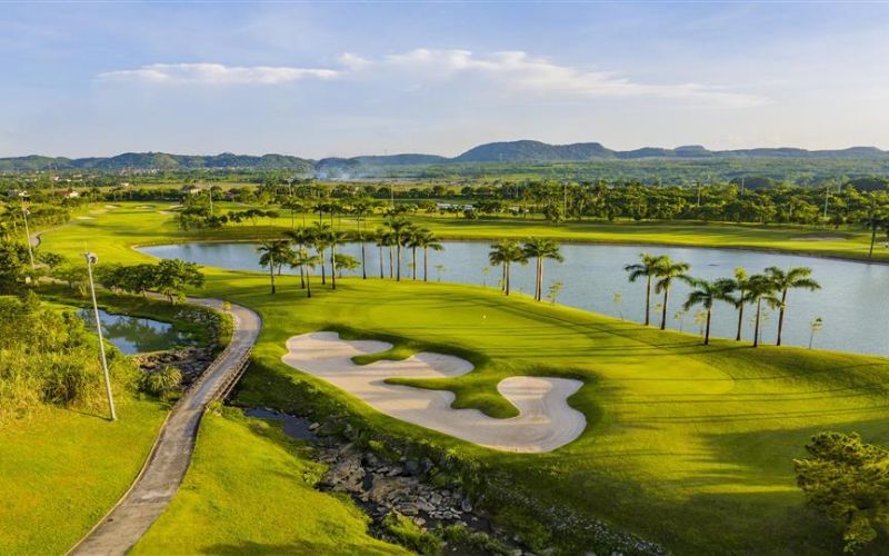Lush green fairways and water features at Trang An Golf & Country Club in Ninh Binh.