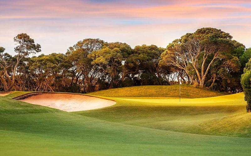 Lush fairways and rolling greens at Aguinaldo Golf Course, surrounded by trees and natural landscape