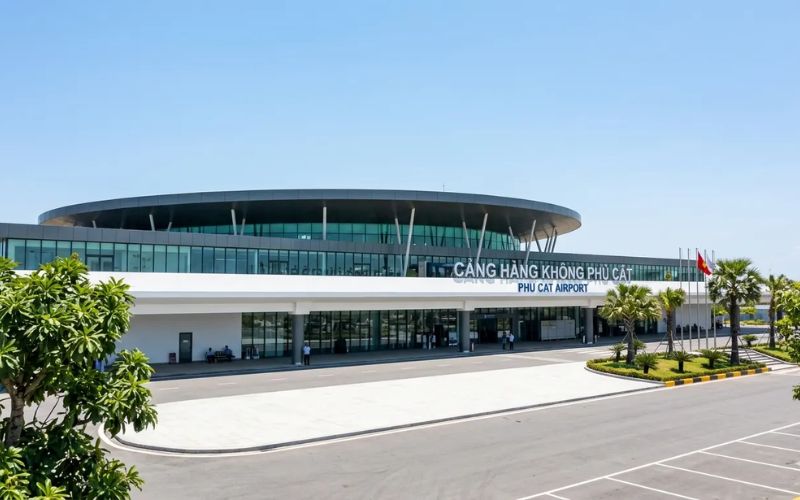 Exterior view of Quy Nhon airport terminal building under a clear blue sky.