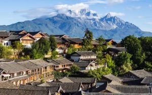 Traditional rooftops of Lijiang Old Town overlooking Jade Dragon Snow Mountain in Yunnan, China