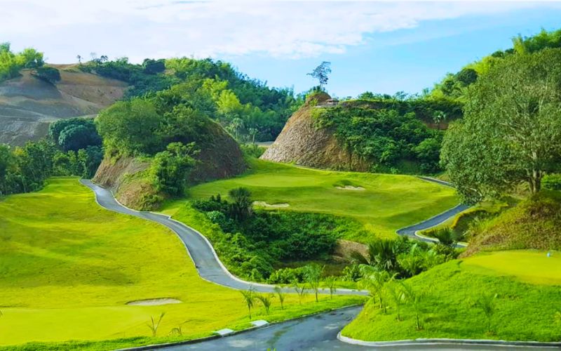 Liloan Golf Course in Cebu, Philippines, showcasing rolling fairways surrounded by lush green hills